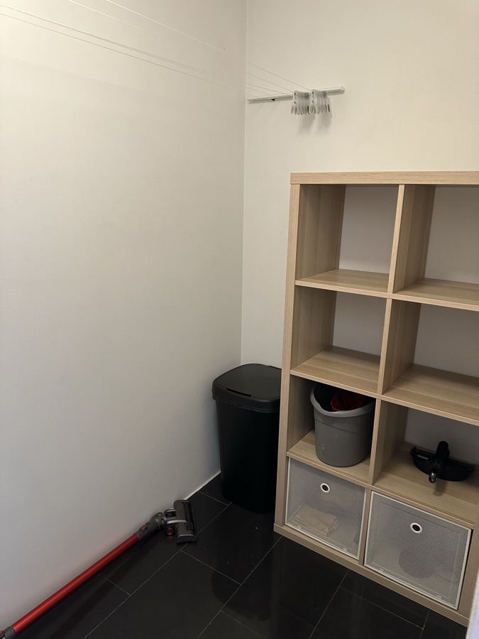 Storage room with an open shelving rack and storage baskets