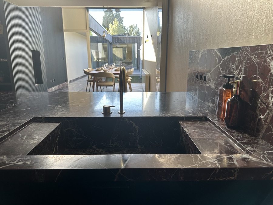 View across the sink towards the dining table and the terrace