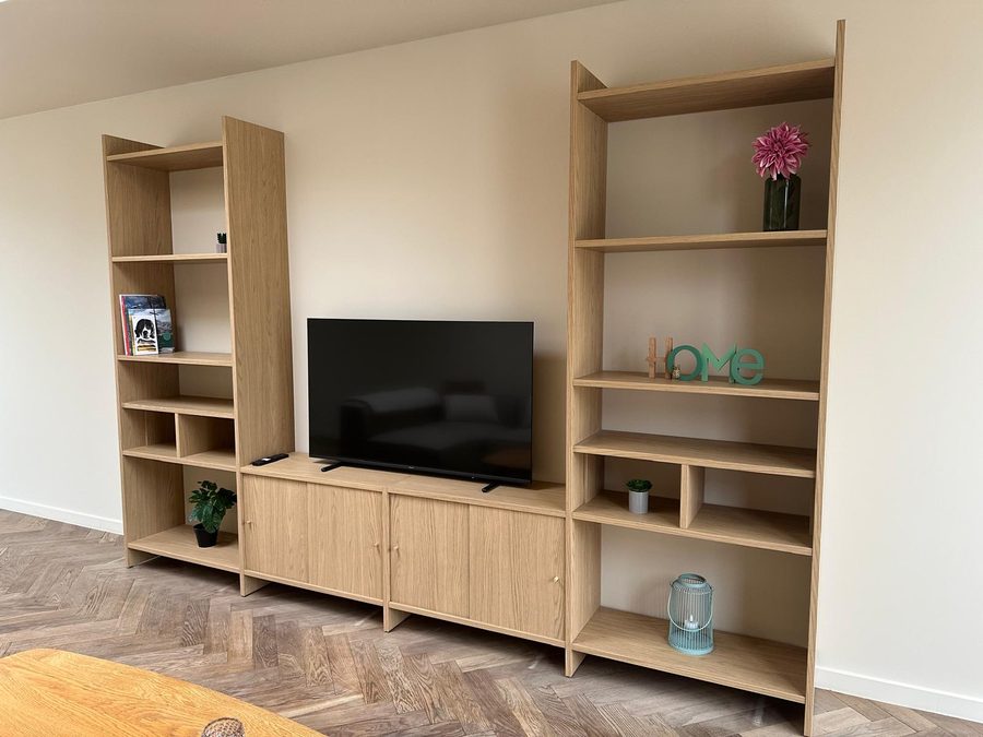 Oak TV unit with open shelves and a television in the living room