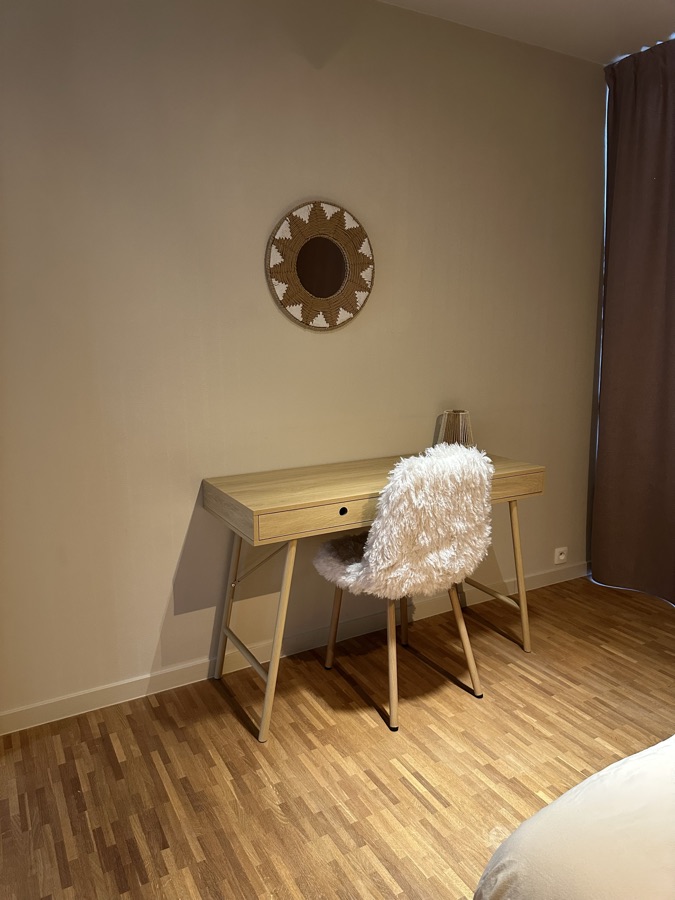 Wooden desk with a sheepskin chair and round wall decoration